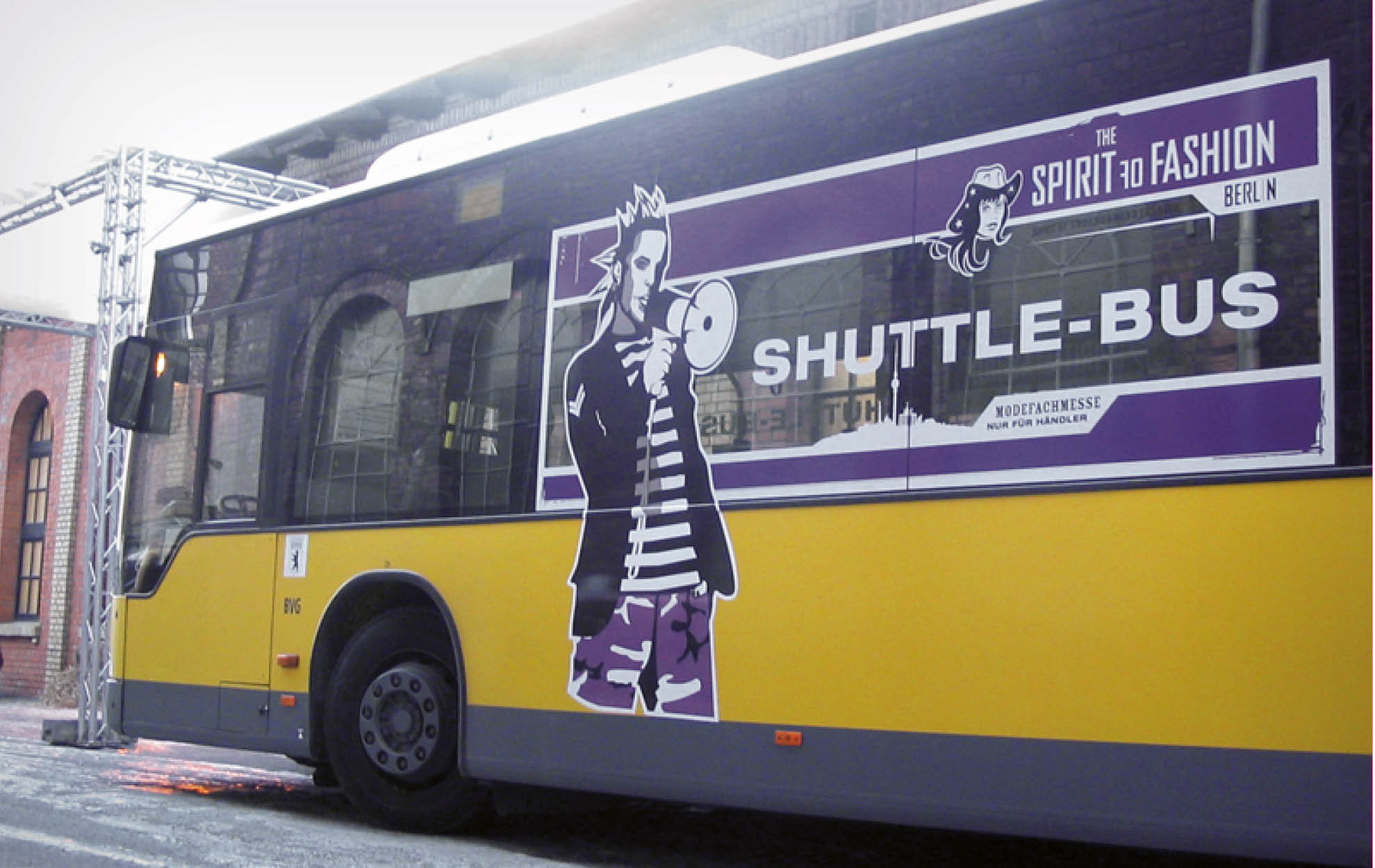 The Spirit of Fashion – Shuttlebus Design Gebrandeter Shuttlebus der Modemesse „The Spirit of Fashion Berlin“ mit auffälliger Illustration und violettem Branding.