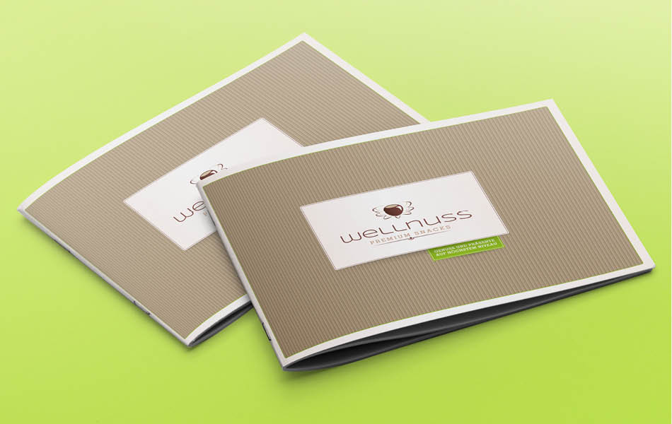 Wellnuss – Verpackungsdesign Geschenkboxen Farbige Geschenkboxen von Wellnuss Premium Snacks mit verschiedenen Editionen wie „Herzlichen Glückwunsch“, „Frohe Ostern“ und „Herrenabend“.